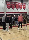 UNM Lobo coach Eric Olen, center in red, talks with high school junior and Lobo recruit Tavid Johnson while UNM assistants and freshman guard Jake Hall eft, gather nearby after a high school game in Solana Beach, California, on Friday,  Jan. 16, 2026.