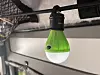 Small green battery lantern hanging from an interior support rod.