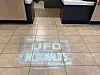 Floor projection reading UFO McDonald’s Roswell, NM inside a McDonald’s restaurant.