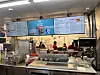 Blake’s employees behind a counter preparing breakfast burritos in a fast-casual restaurant.
