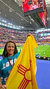 Valerie Flores holding her New Mexico state flag at AT&T/Dallas Stadium in Arlington, Texas, ahead of the July 3 Egypt/Australia World Cup match.