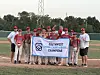 Youth baseball team from Roadrunner Little League in Albuquerque, New Mexico, holding a championship banner on a baseball field.