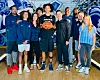 Brandon Mason Jr. and his family pose with Xavier University basketball coaching staff.