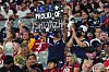 A football fan holding up a sign in the stands that reads 'We R prous of Shiyazh.'