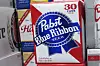 Pabst Blue Ribbon cases of beer stacked in a commercial warehouse environment representing the stolen cargo