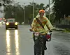 Lori Burton rides home in the rain.